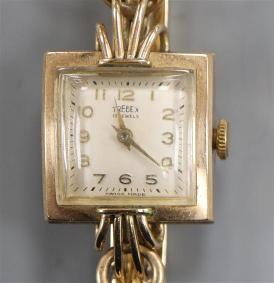 A ladys 9ct gold Trebex manual wind wrist watch, on a 9ct bracelet.